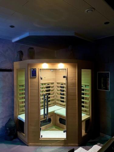 a display case with a mirror in a room at Villa Cerf - SPA Privé, Climatisation, Sauna, Borne d'arcade, Babyfoot in Ittenheim