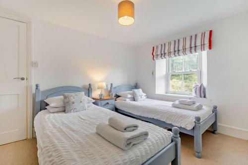 a bedroom with two beds with towels on them at 2 Bed in Wadebridge oc-r27444 in Little Petherick
