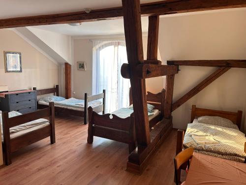 a bedroom with four bunk beds and a window at Agroturystyka Maya in Gorzyca