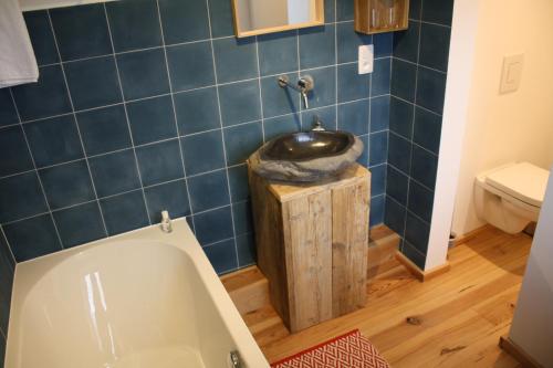 a bathroom with a tub and a sink at La lune en bulles in Presseux