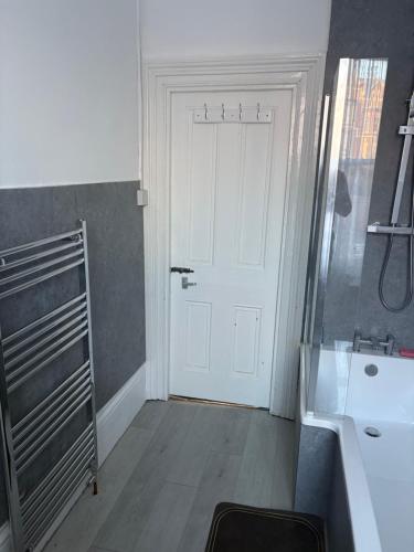 a bathroom with a white door and a sink at Palace in Crystal Palace