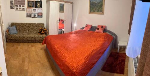 a bedroom with a bed and a couch in it at Zukalka 2KK - 1 in Ostrava