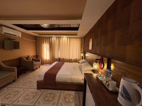 a hotel room with a bed and a couch at Eagle's Nest Hotel in Karimabad Hunza