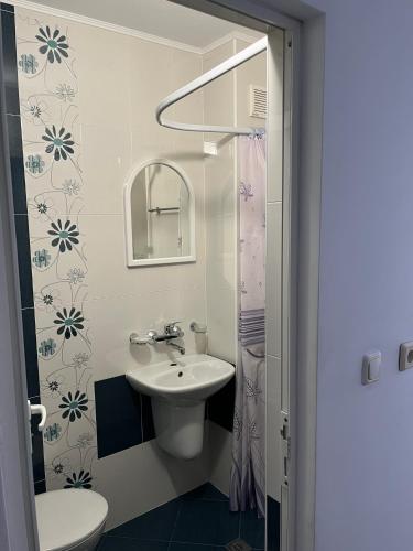 a white bathroom with a sink and a mirror at kaLe in Ravda