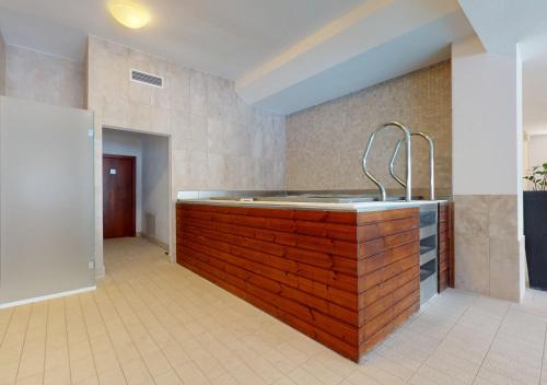 a kitchen with a wooden counter with a sink at Apartmán Deluxe Jasná in Belá