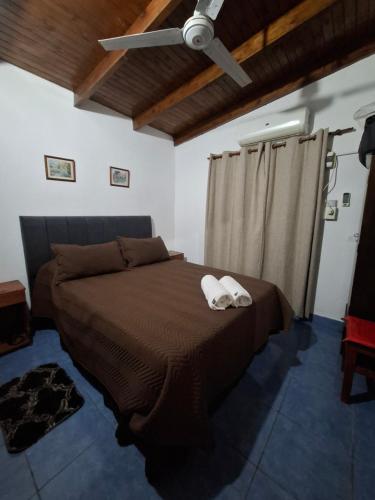 a bedroom with a bed with two towels on it at Iguazú Cabañas in Puerto Iguazú
