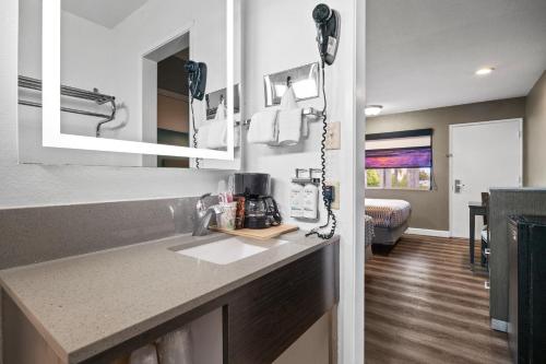 a kitchen with a counter top and a sink at Hotel Palmeras Chula Vista in Chula Vista