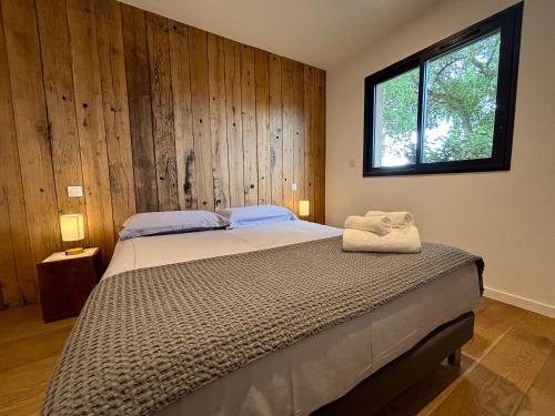 a bedroom with a large bed with a window at Villa Sébastien by Intendance Excellency in Zonza