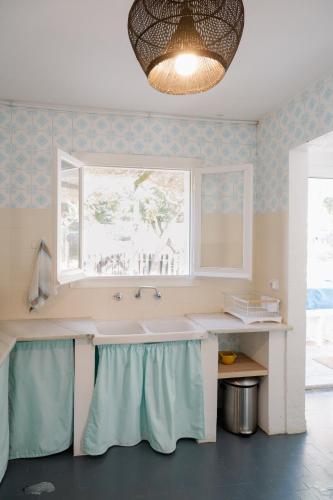 a kitchen with a large sink and a window at Masia Can Pares in Sant Pere de Ribes