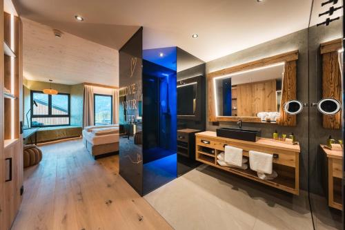 a bathroom with a sink and a mirror at Hotel Panorama Royal in Bad Häring