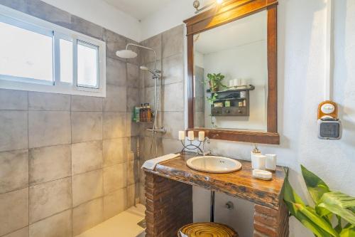 a bathroom with a sink and a mirror at Cubo's Cortijo La Olivera in Antequera
