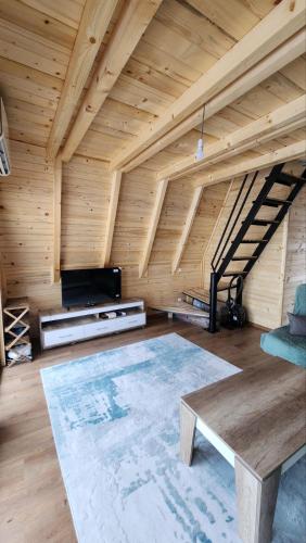 an attic room with a wooden ceiling and a table at Villa Qukapiku in Orllan