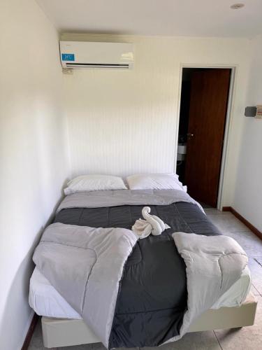 a large bed with a white towel on top of it at Finca los Cauquenes Chascomus in Chascomús