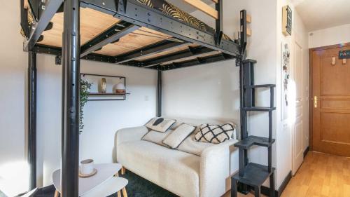 a loft bed with a couch in a room at Le Birdie NI105 - ST2 in Giez