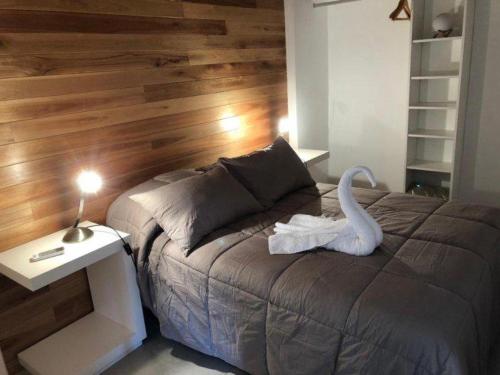 a bedroom with a bed with a swan on it at Finca los Cauquenes Chascomus in Chascomús