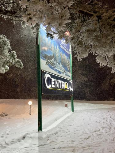 a sign in the snow next to a tree at Central green in Divčibare