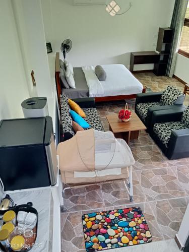 a living room with couches and a couch at Super View Home Stay in Ella