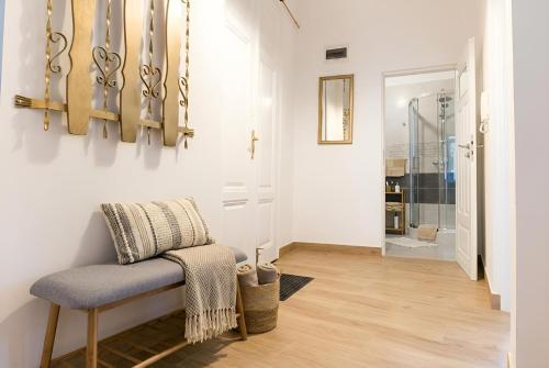 a hallway with a chair and a walk in shower at Mid Apart Mennicza Cieszyn in Cieszyn