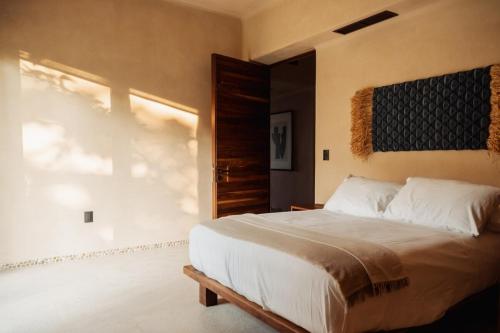 a bedroom with a large bed and a window at Luxury Apartment in Playa Blanca Zihuatanejo CAUMA in Zihuatanejo