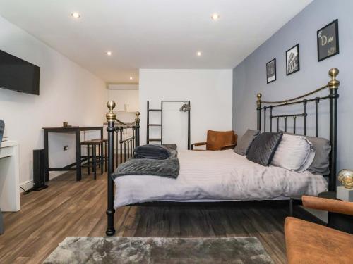 a bedroom with a bed and a living room at Chalet 2 in Ganton