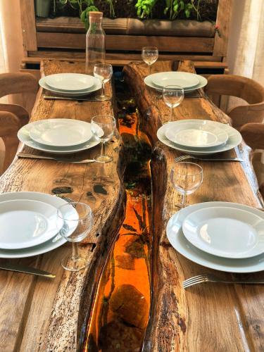 a wooden table with plates and wine glasses on it at Le Damier in Castres