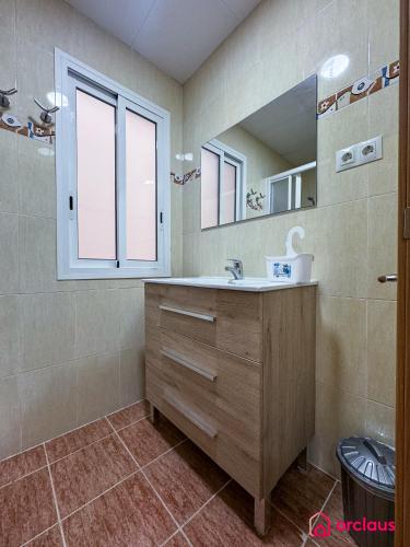a bathroom with a sink and a mirror at El Piso Bajo in San Juan de Moró