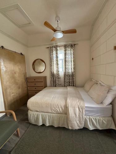 a bedroom with a bed and a ceiling fan at Windy Nook - The Contemporary Tiny Home in Saint Philip
