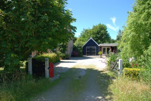 a driveway leading to a house with a garage at Meer en Zee in Scharendijke