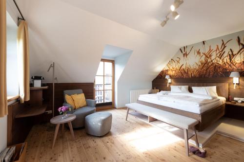 a bedroom with a large bed and a couch at Die Landhofmühle in Windisch Minihof