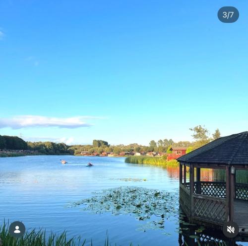 a view of a river with people in a boat at Blue Water Retreats in Carnforth