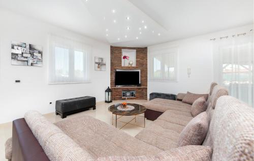 a living room with a couch and a tv at Gorgeous Home In Rovinj in Rovinj