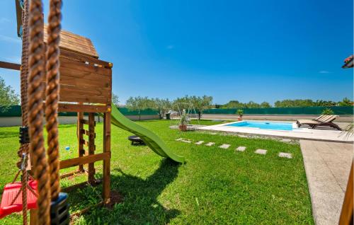 a playground with a slide and a swimming pool at Gorgeous Home In Rovinj in Rovinj