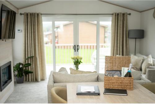a living room with a couch and a table at Blue Water Retreats in Carnforth