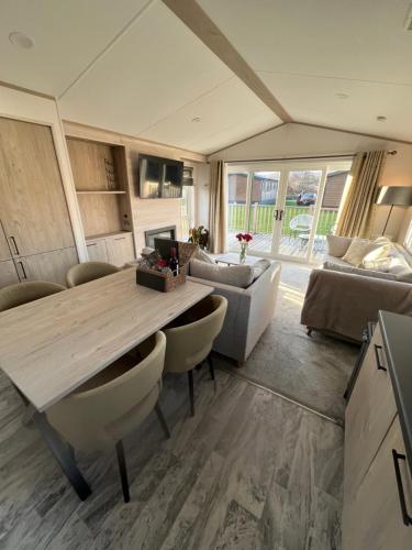 a living room with a table and a couch at Blue Water Retreats in Carnforth