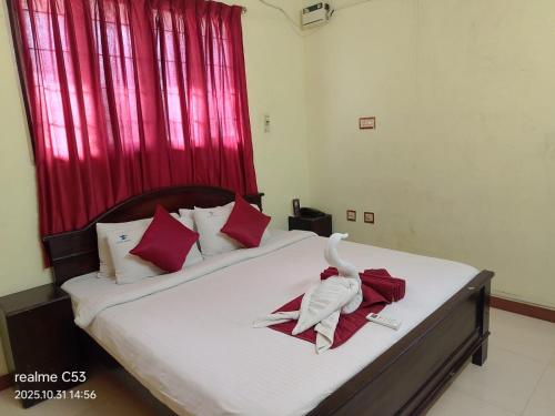 a bedroom with a bed with a towel on it at Hotel Raaj Inn Service Apartment in Chennai