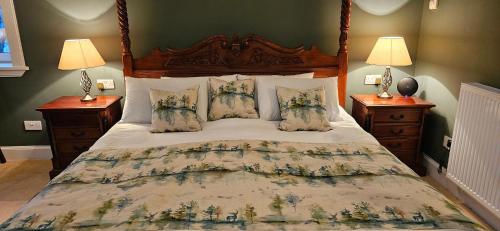 a bedroom with a large bed with two lamps at Butt Lodge in Lochranza