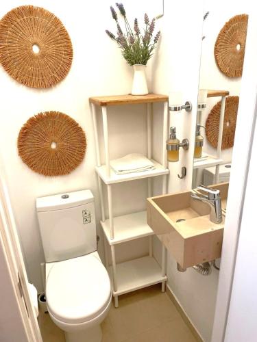 a bathroom with a toilet and a sink at Don Sebastiao in Sesimbra