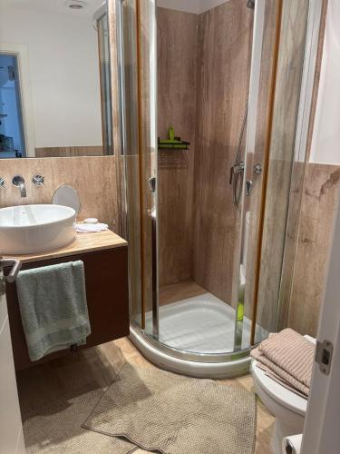 a bathroom with a shower and a sink at Spacious open plan ground floor apartment in Port de Pollensa
