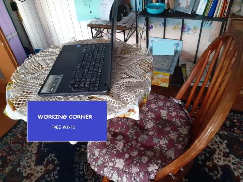 a laptop computer sitting on a table with a chair at Room country-lake in Dormelletto