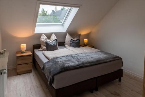 a bedroom with a bed with a window on it at Panorama-Blick Brüggen in Brüggen