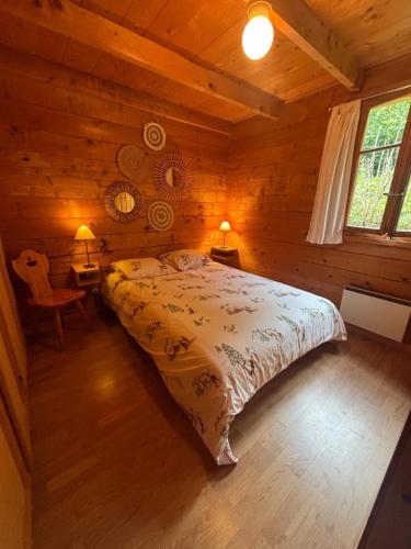 a bedroom with a bed in a log cabin at Chalet Dar El Jebel in Evolène