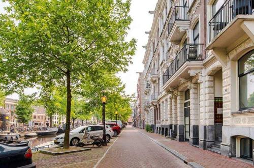 a city street with cars parked on the street at studio at the Rijksmuseum in Amsterdam