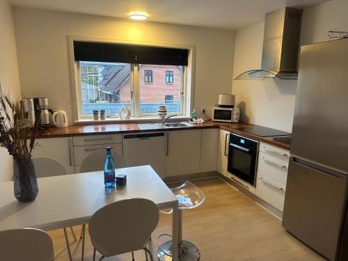 a kitchen with a table with a bottle on it at Apartment in the center of Herning in Herning