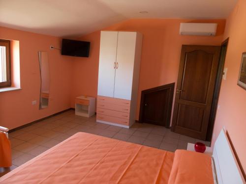a bedroom with a bed and a white cabinet at B&B Verde Irpinia in Gesualdo
