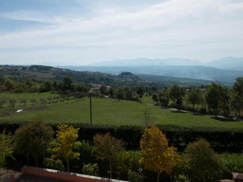a view of a green field with mountains in the distance at B&B Verde Irpinia in Gesualdo