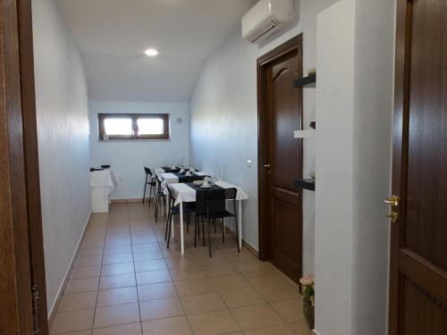 a dining room with a table and chairs at B&B Verde Irpinia in Gesualdo