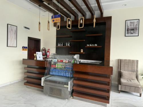 a coffee shop with a counter in a room at Alqasr Almutar Hotel in Abha