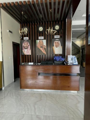 a cash register in a store with clocks on the wall at Alqasr Almutar Hotel in Abha