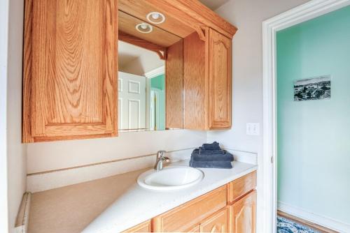 a bathroom with a sink and a mirror at La Maison - Elegant 2BR Escape - Free Breakfast! in Albany