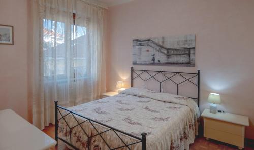 a bedroom with a large bed and a window at Casa Niky in Verbania